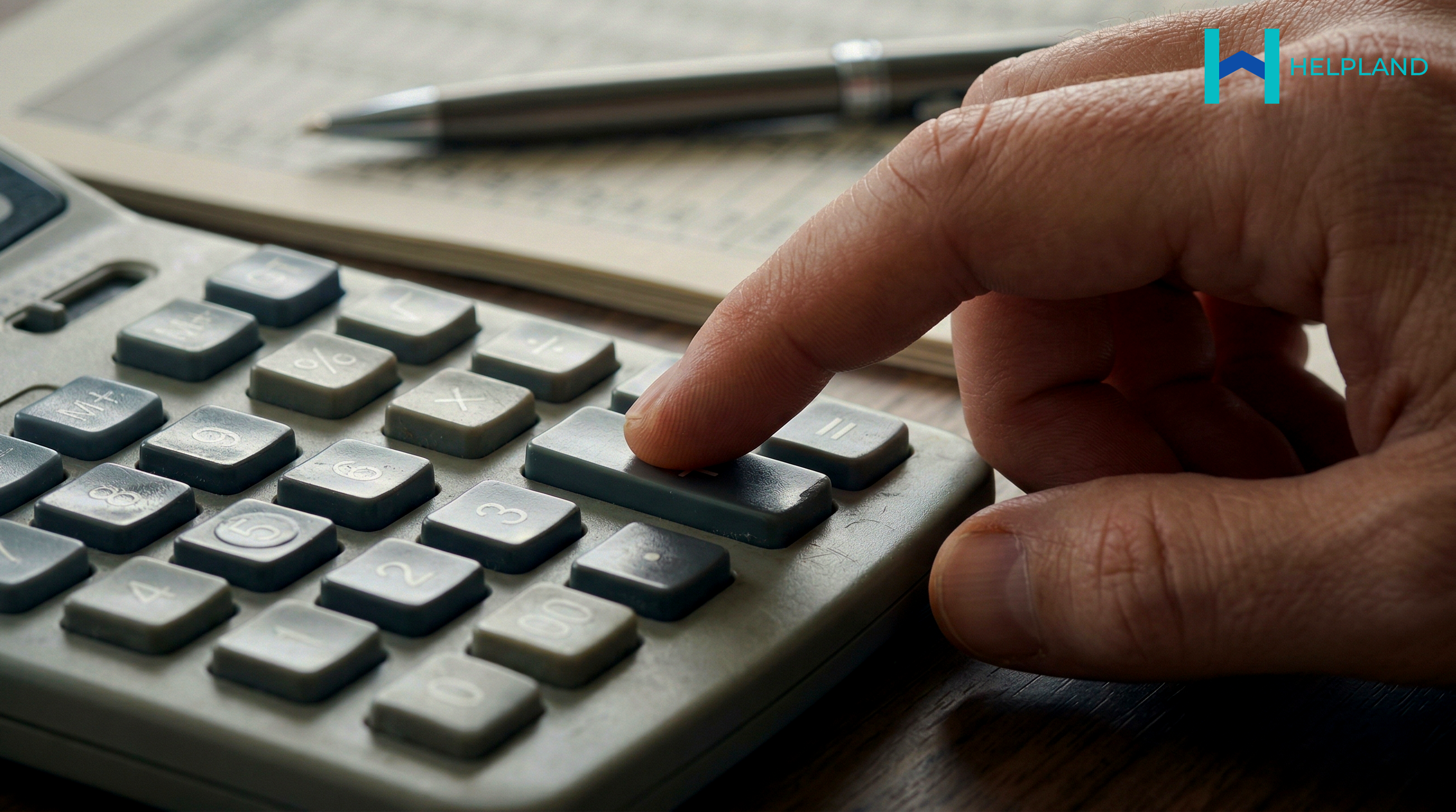 Close up of landlord using calculator 